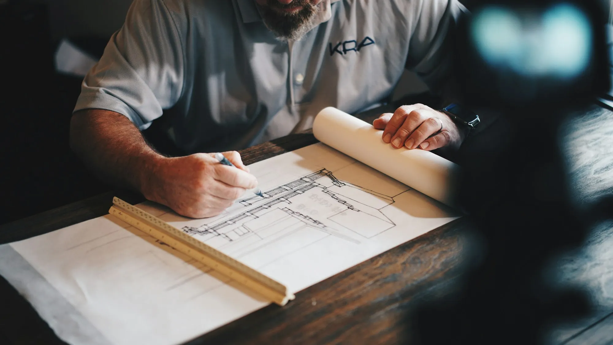 Reviewing building plans at a desk