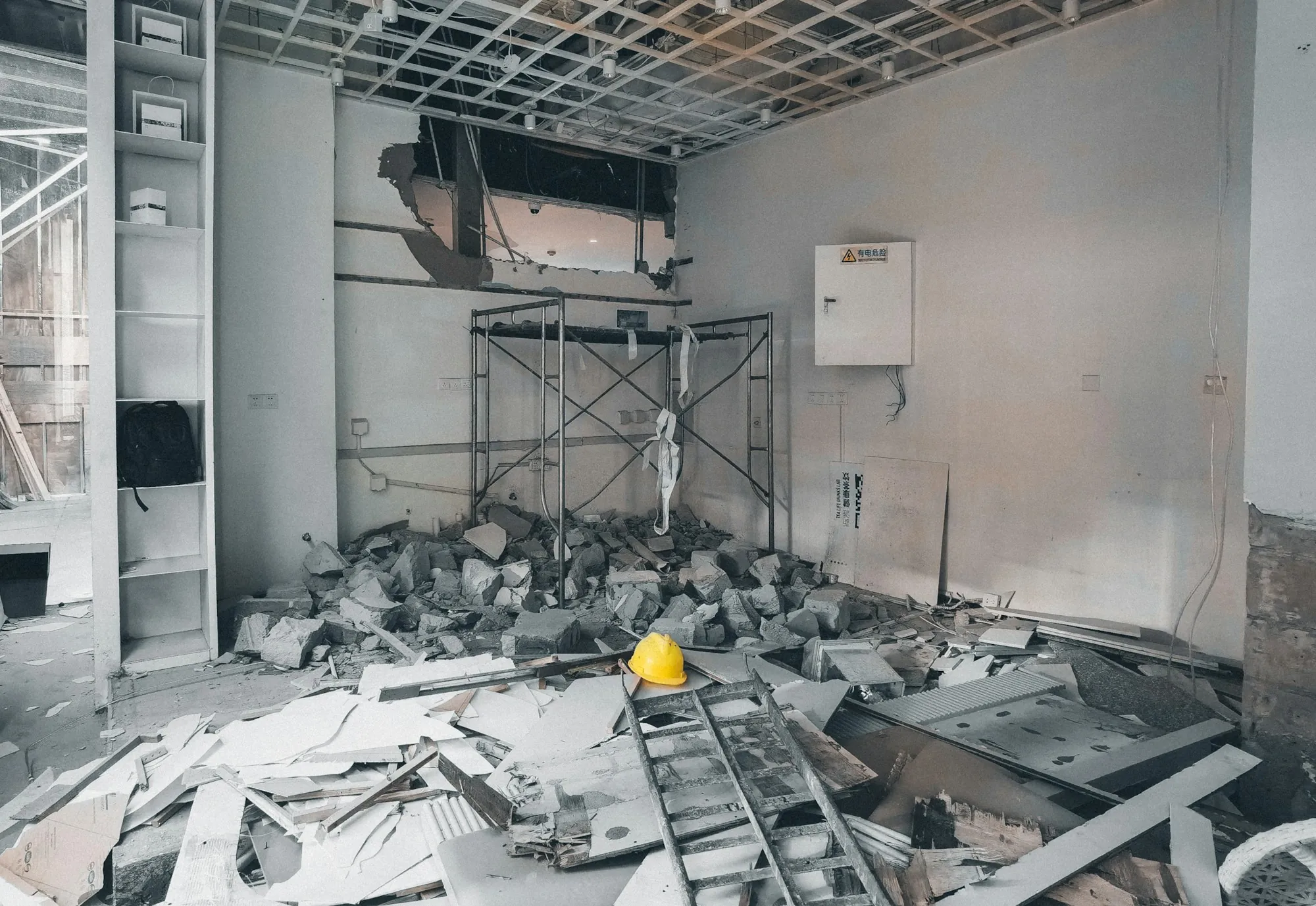 Room cleared to the shell with debris piled on the floor