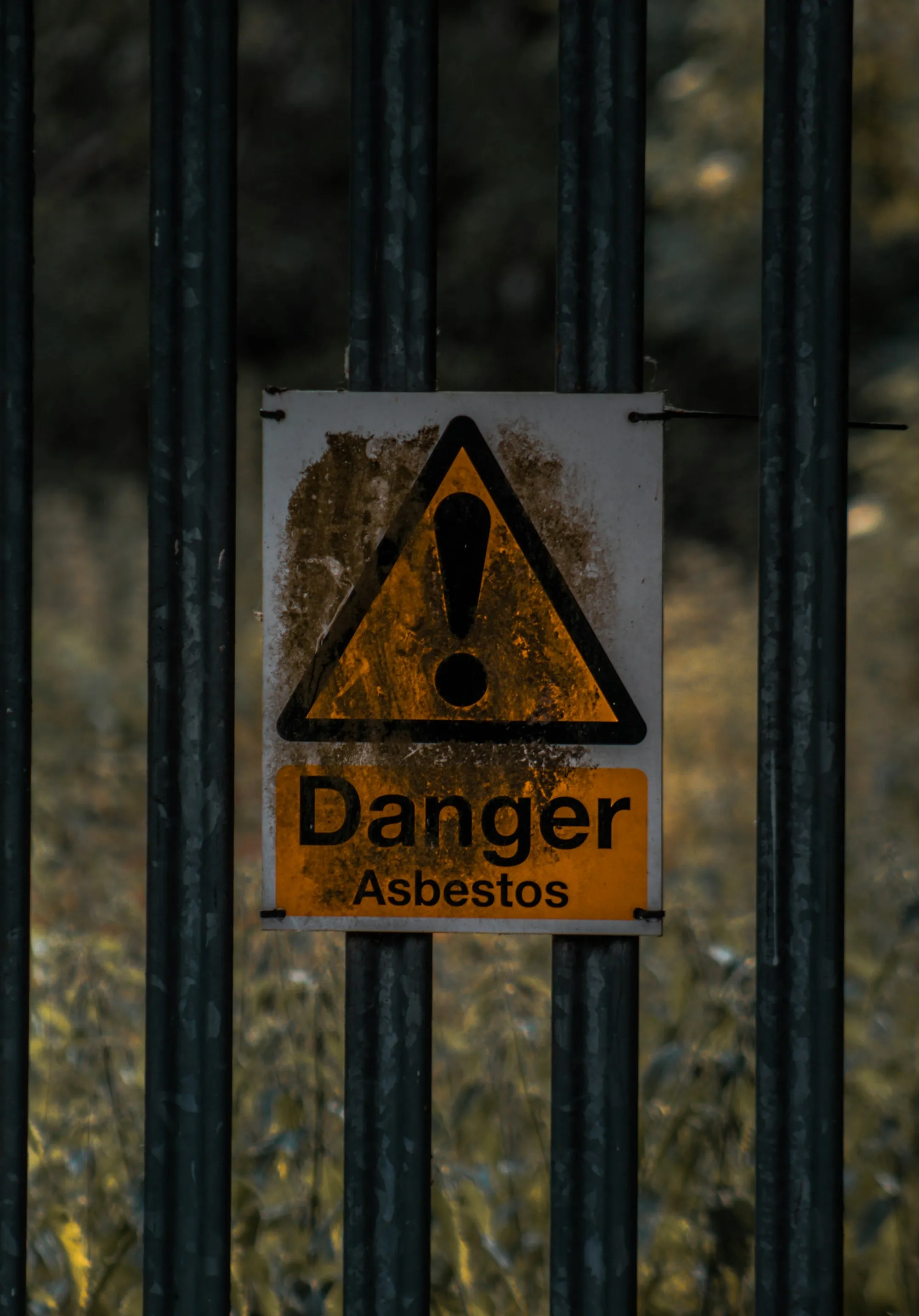 Weathered danger asbestos warning sign